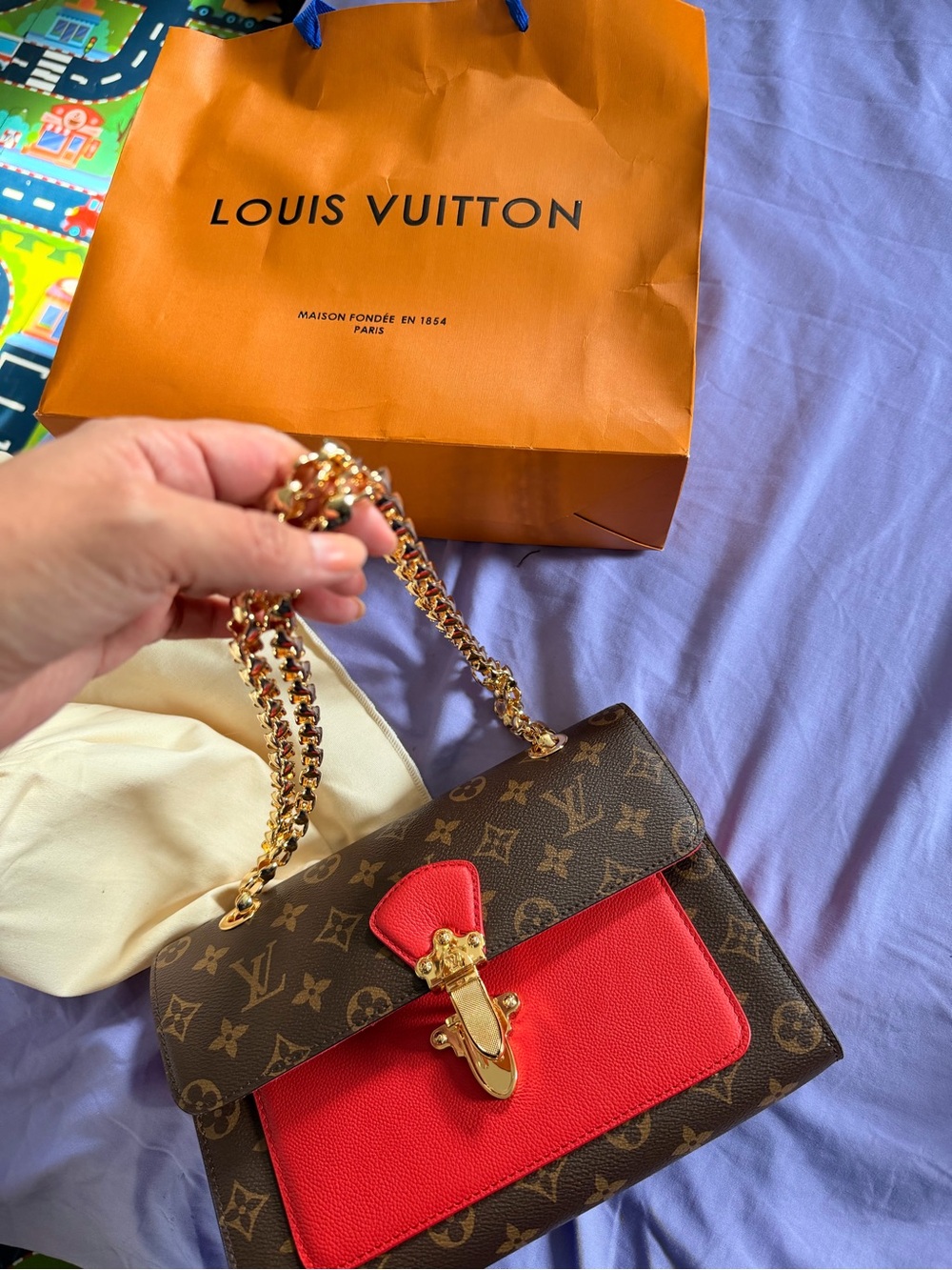 Louis Vuitton Brown Monogram Shoulder Bag with Red Accent and Gold Chain
